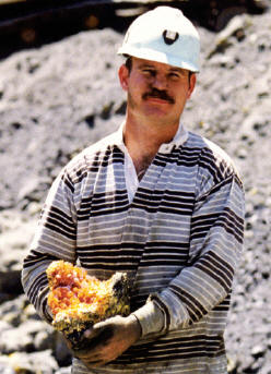 Graham Sutton of Collector’s Edge with freshly mined high quality orpiment specimen. Collector’s Edge photo.