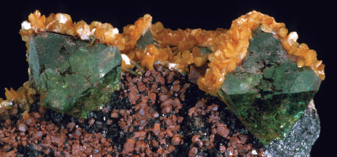 Fluorite with stilbite and hematite-coated quartz from the Christmas Tree Pocket, largest fluorite is 2.5 cm. P. Lyckberg specimen. J. Scovil photo.